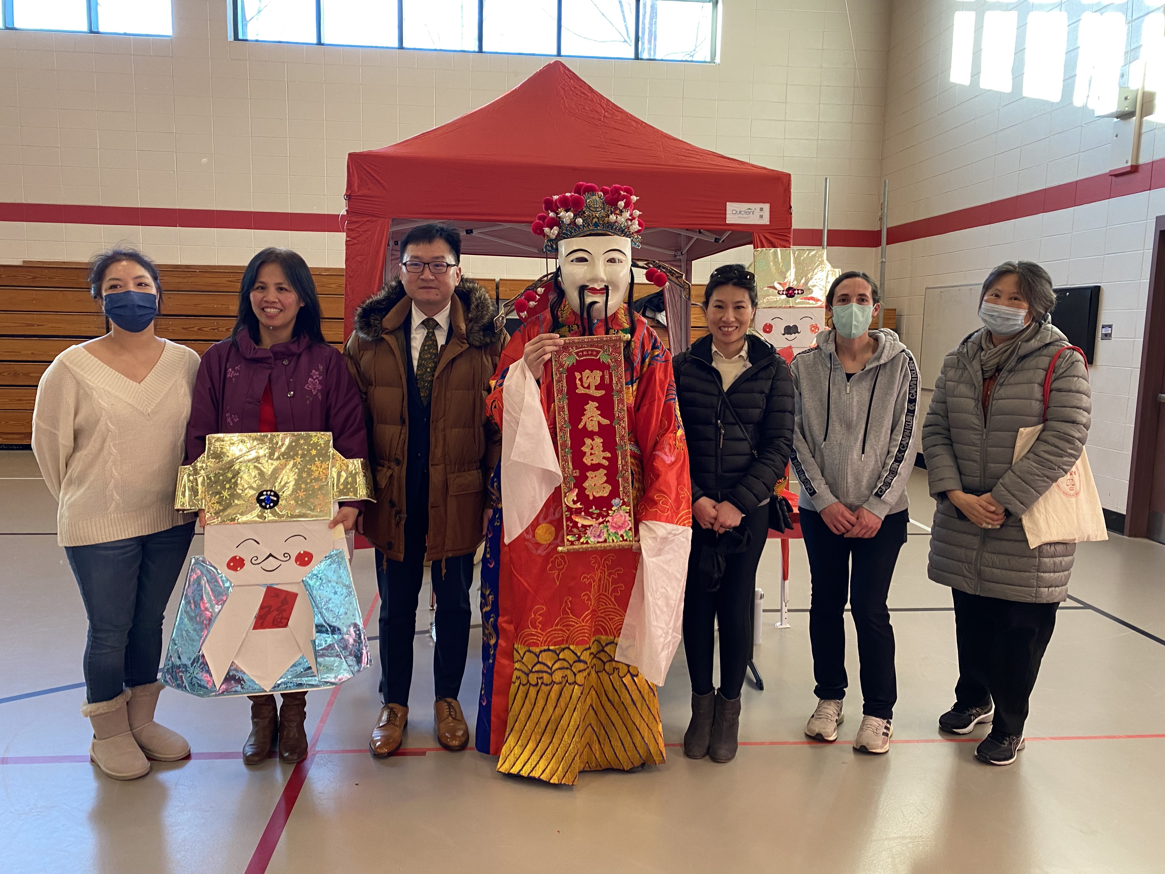 波士頓僑教中心主任潘昭榮與財神爺, 及年貨大街工作人員和義工合照